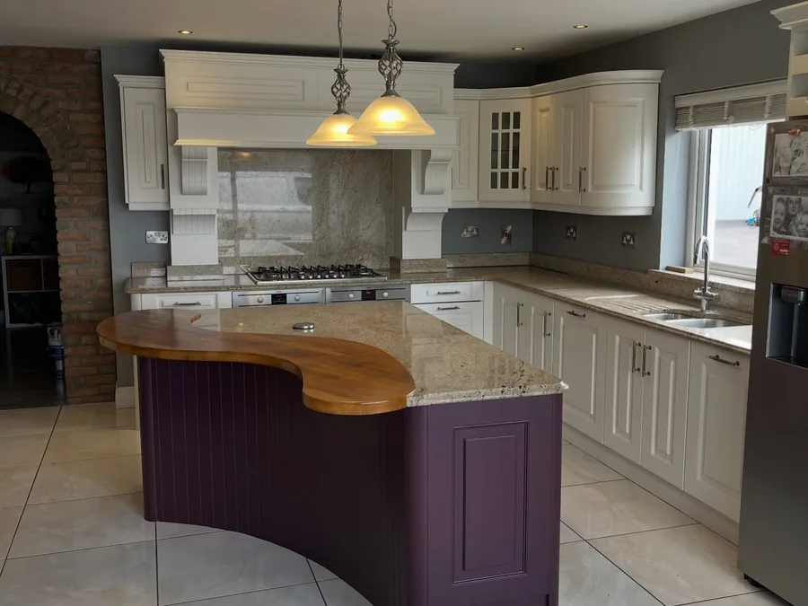 Cream kitchen with a plum-coloured island and timber worktop