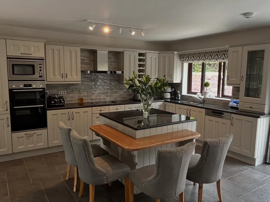 Kitchen resprayed in a warm stone grey, with a family dining table